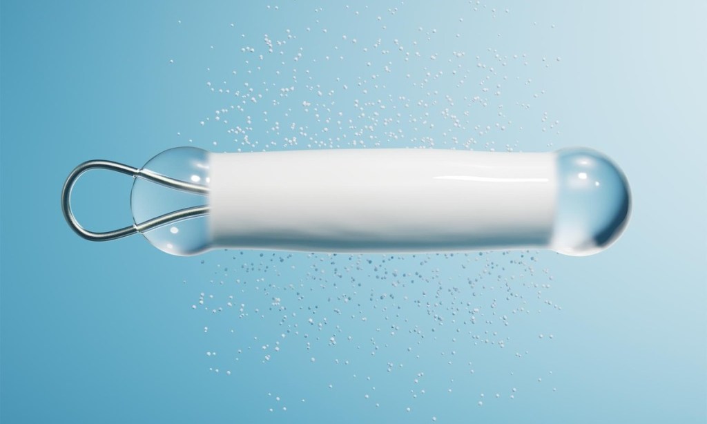 Illustration of the Encelto device, a tiny capsule designed for implantation in the eye to deliver therapeutic proteins.