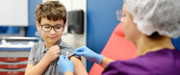 Child receiving a vaccine from a healthcare professional during a pediatric visit.